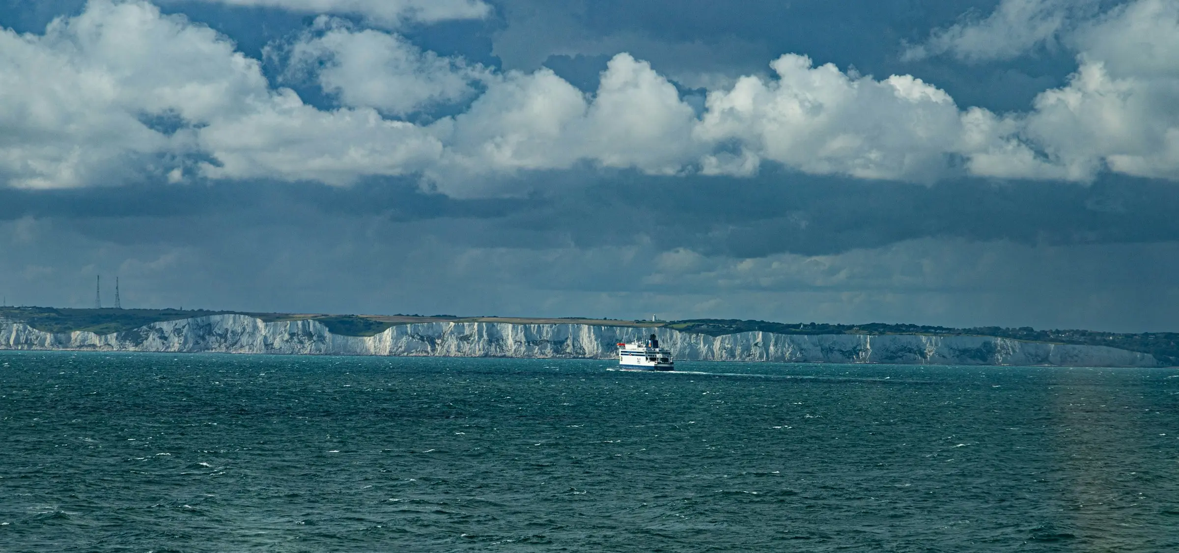 The white cliffs of Dover seen from the Channel, a ferry crossing beneath them